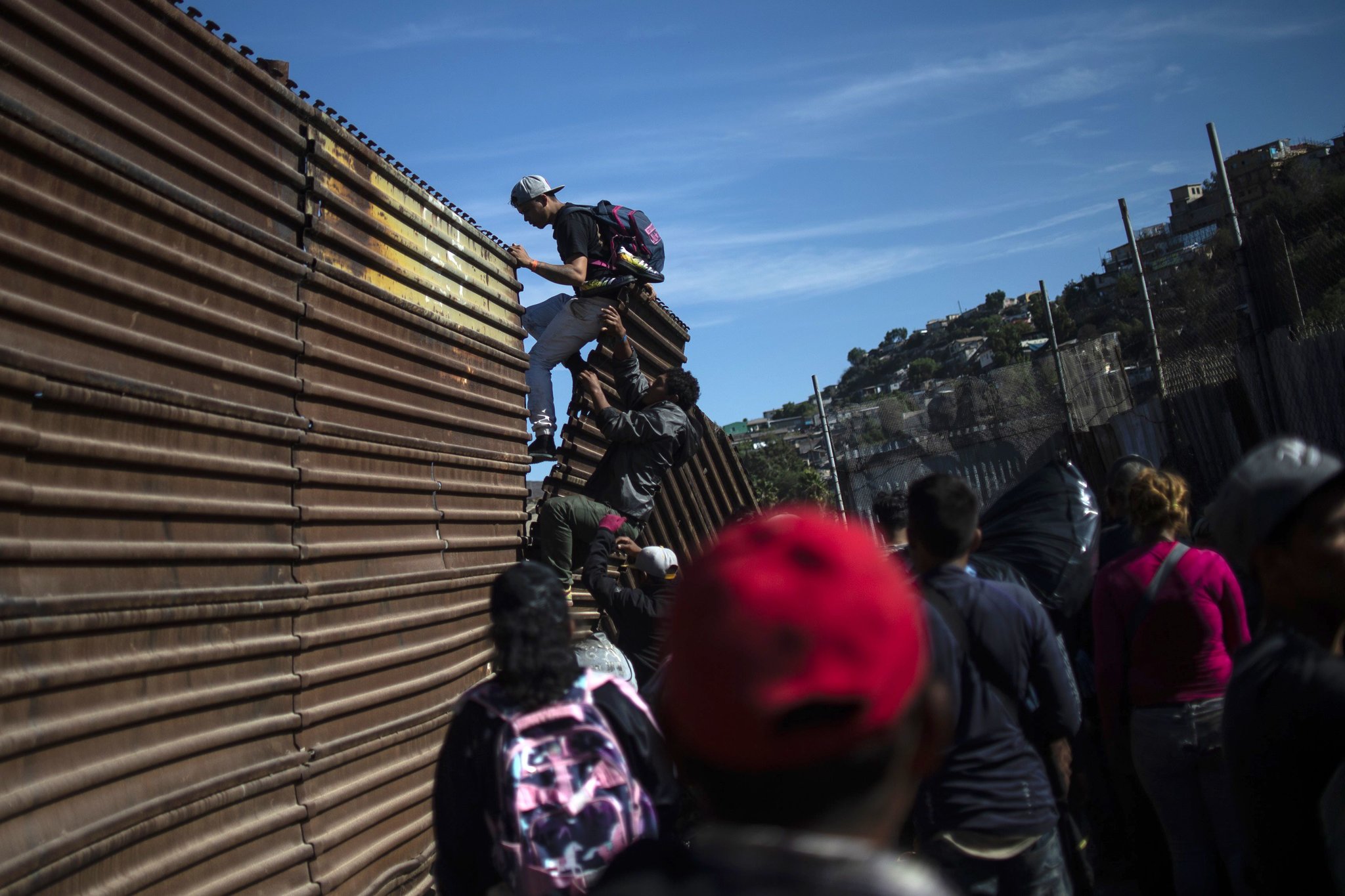 Migrants In Tijuana Run To U S Border But Fall Back In Face Of Tear